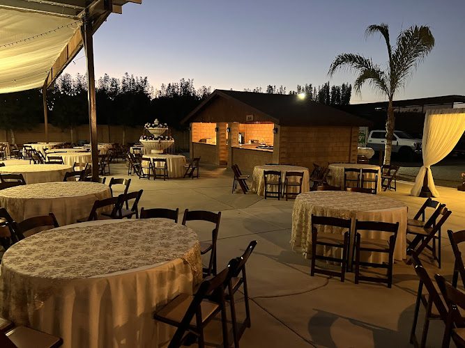 A real evening at Rancho El Alamo — banquet tables and string lights on the celebration patio at dusk